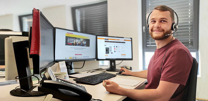 Support-Mitarbeiter am Arbeitsplatz Mann mit Headset arbeitet an einem Computer